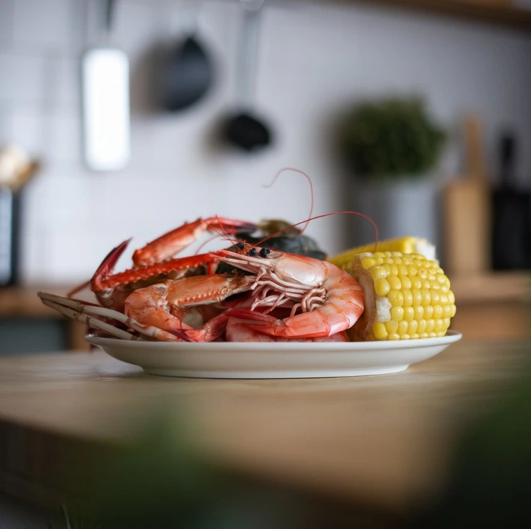 Seafood boil with shrimp, crab, corn, and potatoes spread on a table